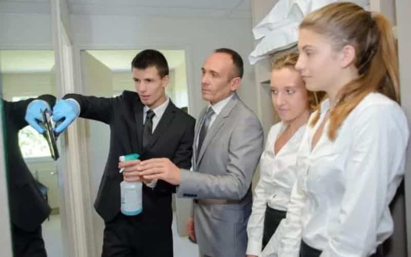A Man teaching two Ladies how to clean