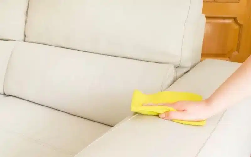 Cleaning a Dirty Faux Leather Couch using a Yellow towel