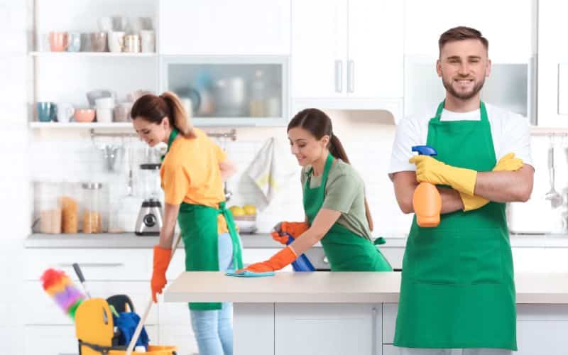 team professional janitors uniform cleaning kitchen